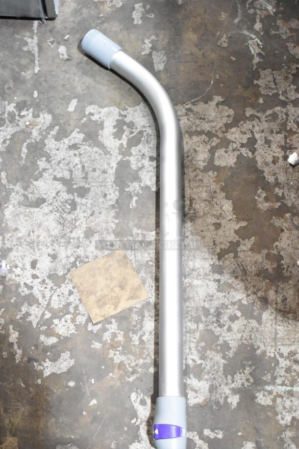 Vacuum attachment wand for ProTeam 1076420, showing light wear, on scratched surface. Silver tone with gray connectors.