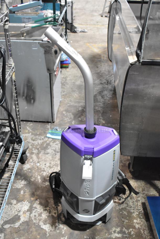 BRAND NEW ProTeam 1076420 backpack vacuum cleaner, purple and gray, with visible carry straps and label, light scratch marks.