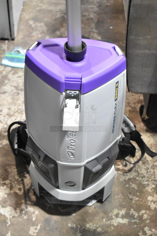 BRAND NEW ProTeam 1076420 Backpack Vacuum Cleaner, scratch and dent condition, purple and gray with visible labels.