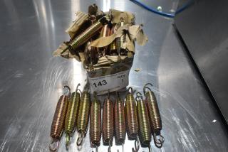 Box of new metal door springs, slight packaging damage. Springs are coiled, various colors. Label reads "143, QTY 1".