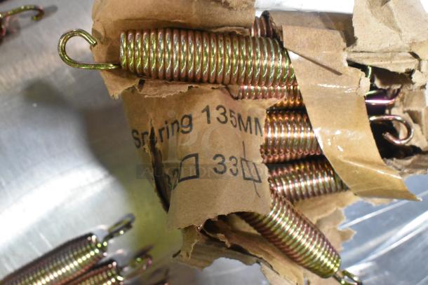 Box of metal door springs, brand new, with scratch and dent. Marked as "Spring 135MM."