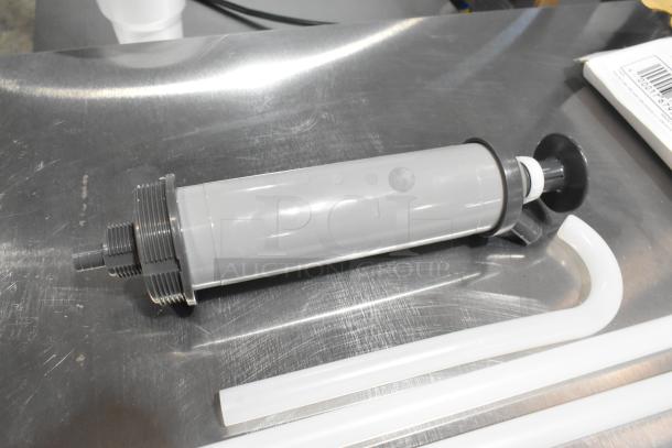 BRAND NEW SCRATCH AND DENT Noble 2.5-55 Gallon Adjustable Pail Pump Dispenser, gray, unused condition, visible barcode.