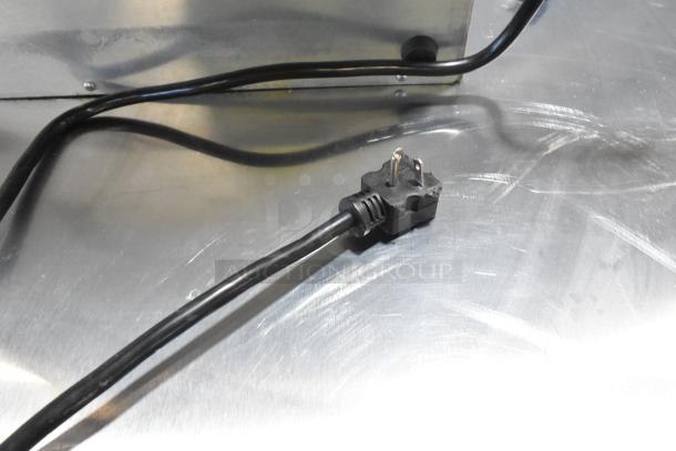 BRAND NEW SCRATCH AND DENT! Avantco 177FW200D dual well food warmer plug on metal surface. 120V, 1 phase.