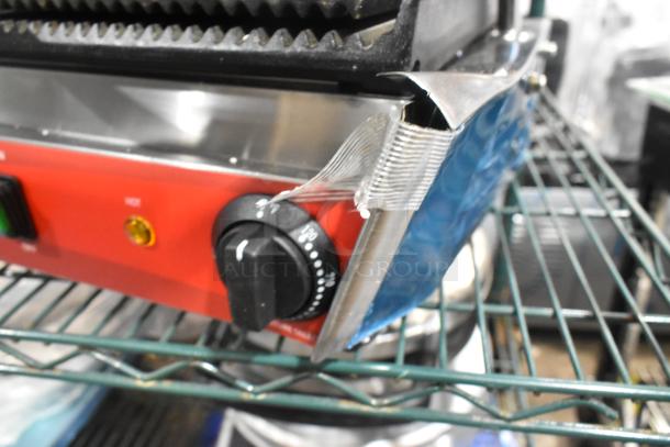 Brand new Avantco 177PG400 dual panini grill, stainless steel, grooved plates, 19 5/8" x 9 1/8" cooking area, scratch and dent condition.