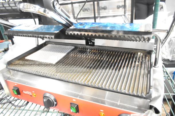 Brand new Avantco 177PG400 dual panini grill with grooved plates, 19 5/8" x 9 1/8" surface, 120V, stainless steel.