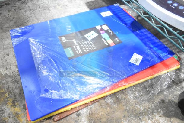 Set of 12 new, colorful scratch and dent cutting boards, including sizes 20"x15"x1/2" and 24"x18"x1/2", sealed in plastic.