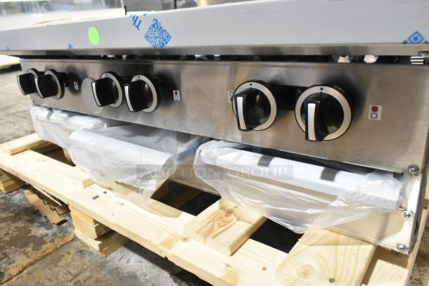 Brand new Garland G36-6T stainless steel 6-burner range, natural gas, with back splash. Scratch and dent condition.