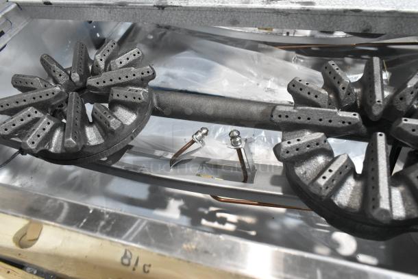Brand new Garland G36-6T stainless steel 6-burner range; natural gas, scratch and dent, commercial use, with back splash.