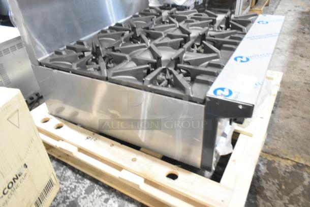 Brand new Garland G36-6T stainless steel 6 burner range, natural gas, with back splash, minor scratch and dent.