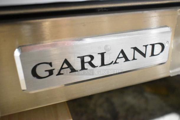 Garland G36-6T stainless steel 6 burner range, natural gas, brand new with scratch and dent markings, logo visible.