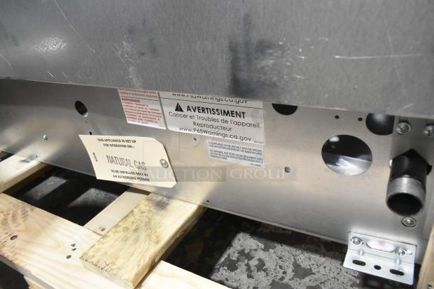 Brand new Garland G36-6T stainless steel 6 burner range, natural gas, slight scratches, includes warning labels, installed on crate.