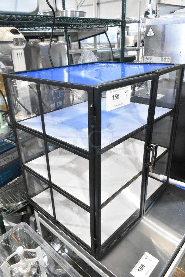 Brand new countertop dry display case merchandiser with minor scratches. Black frame, clear panels, two shelves.