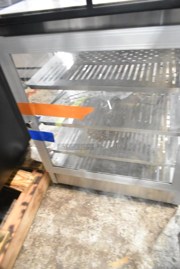 Brand new 2025 Carnival King HPW-12D2S 12" warmer/merchandiser, scratch and dent, 120V, 1 Phase, shelves visible, taped door.