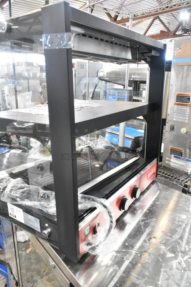 Brand new Avantco 177OAM2A 26" black countertop merchandiser with LED lighting, 2 shelves, and minor scratches. 120V, 1 phase.