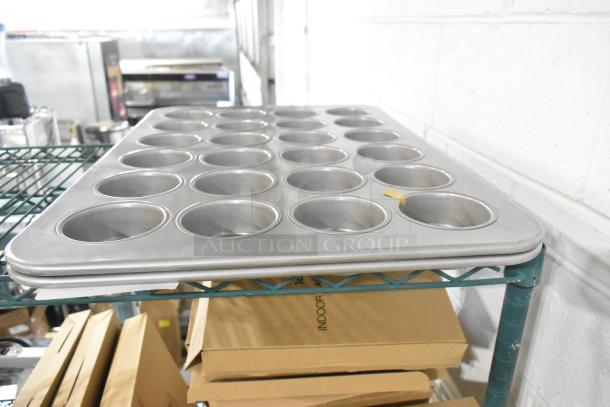 Brand new 24-cup metal muffin baking pans, scratch and dent condition, dual auction offer, visible minimal scuffs.