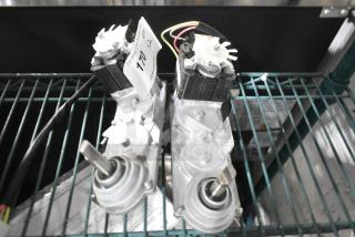 Two brand new units with minor scratches and dents on a wire shelf. Visible tags indicate "170."