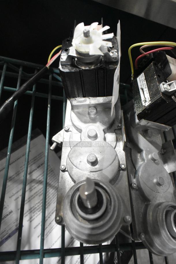 Two brand new scratch and dent motor units with visible wiring and tags, indicating dual auction bid.