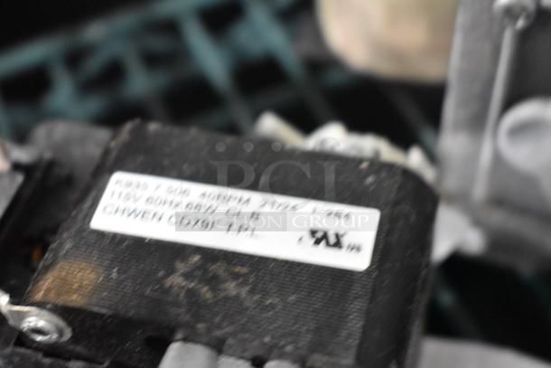 Close-up of a labeled black electrical component; label details include specifications like voltage and amperage.