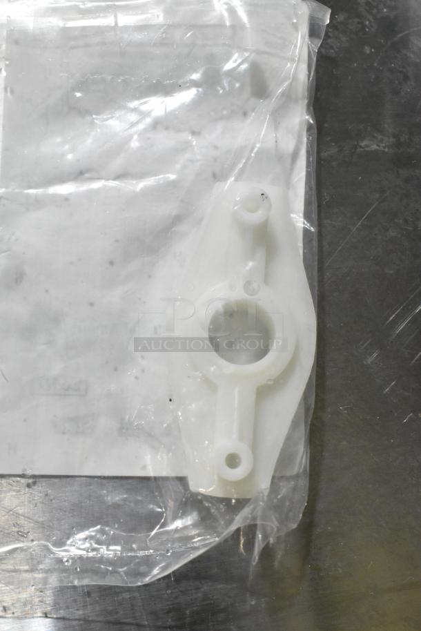 Brand new Hobart 00-941854 hub rinse base, plastic part in sealed packaging, shown on metallic surface.