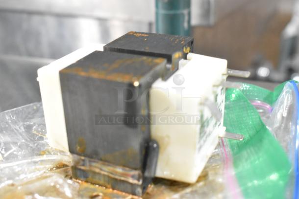 Rusty Hobart assembly part wrapped in plastic, showing signs of wear. Markings unclear. Part of a scratch and dent auction.