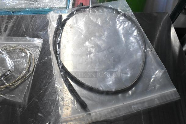 5 Brand New Scratch and Dent items, including Hobart Hub Rinse Base and Assembly, sealed in clear plastic bags.