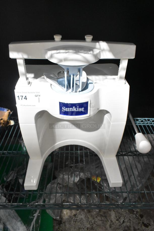 Brand new Sunkist S-100 Commercial Sectionizer, scratch and dent condition. White with Sunkist logo, mounted on metal rack.