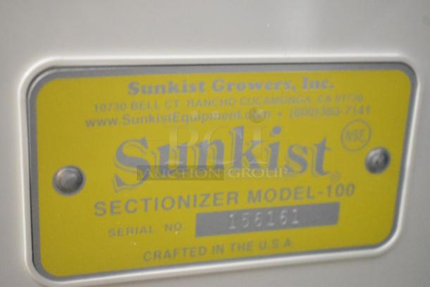 Yellow label on Sunkist S-100 Commercial Sectionizer displaying model, serial number, and contact info. NSF certified.