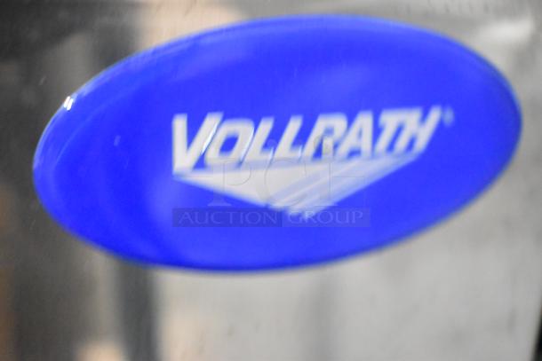 Vollrath logo on stainless steel surface, part of the MIN0012 40743 #12 meat grinder, 110V, 1 phase, brand new condition.