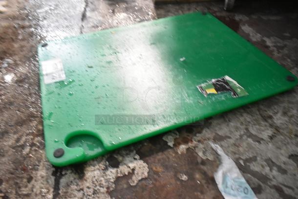 Brand new Choice 407CBG2418GN green cutting board, 24"x18"x1/2", with grips, hook, rulers; slight dents visible.