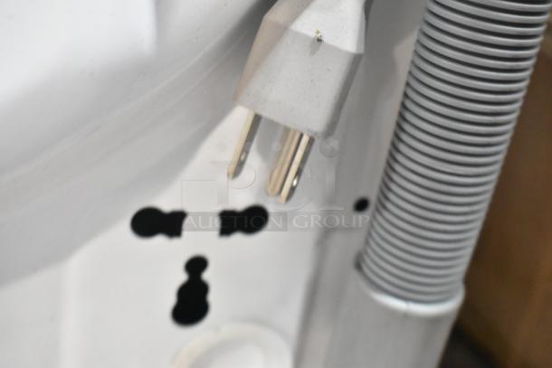 Close-up of the power cord and hose connections for the KoolMore FLC-3CWH washer dryer combo, emphasizing new condition.