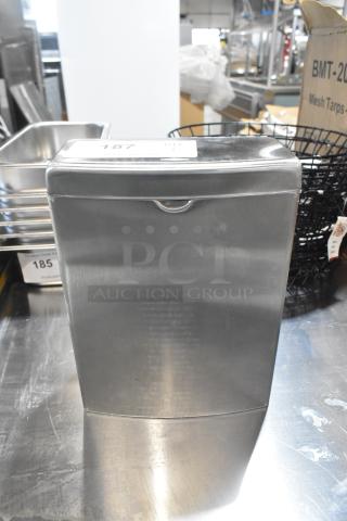 Stainless steel Bobrick bathroom trash can, brand new with minor scratches and dents. Model tag "187" visible on top.