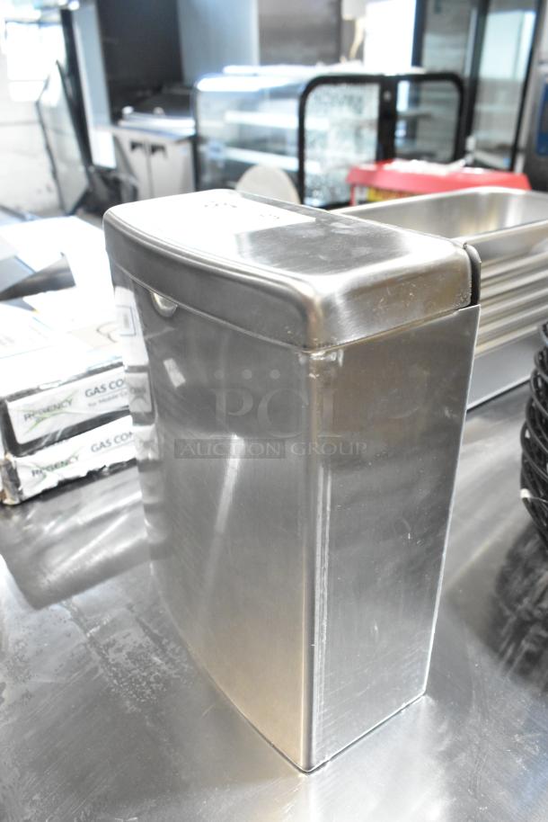 BRAND NEW Bobrick stainless steel bathroom trash can with minor scratches and dents. Sleek design, durable material.