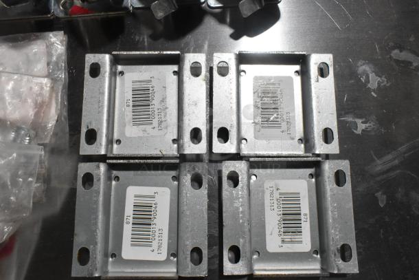 Lot of various scratch and dent items including four metal commercial casters with mounting plates. Barcodes visible.