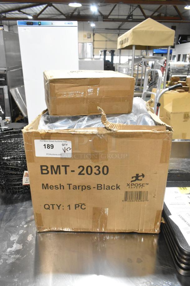 Xpose Safety black heavy-duty mesh tarp, 20' x 30', BMT-2030 model, in original packaging; includes chopstick trainer.