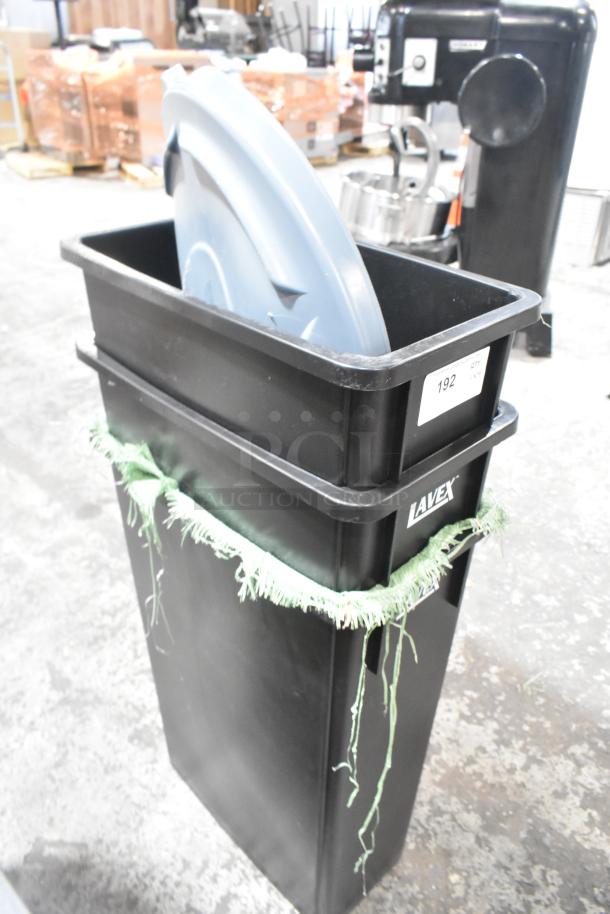 Brand new Lavex 475WH23BK 23-gallon black slim rectangular trash can. Features a green fringe and white label.