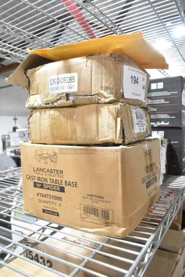 4 new scratch and dent items on a shelf, including Lancaster cast iron table base #164TS1000 and heat lamp base. Boxes are damaged.