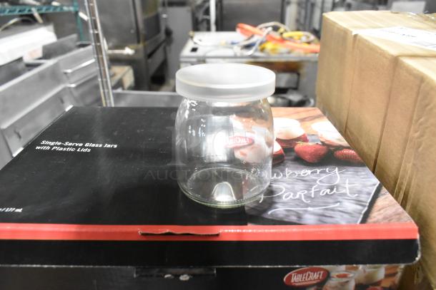 Tablecraft SGJ6 6 oz. glass jar with plastic lid, new condition, displayed on box labeled "Single-Serve Glass Jars."