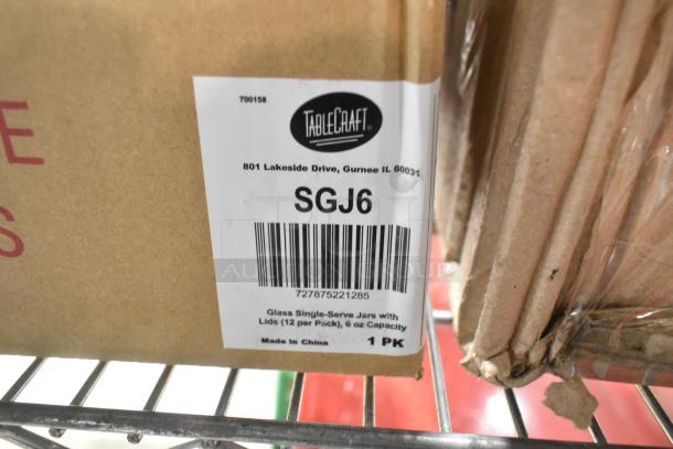 Box of Tablecraft SGJ6 6 oz. glass jars with lids, 12 per pack, new condition.
