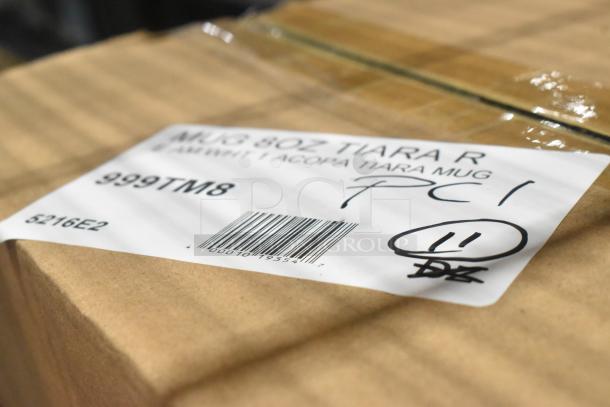 Cardboard box labeled "999TM8 Acopa 8 oz. Tiara Mug" with barcode, hand markings, and SKU 5216E2.