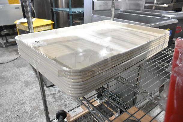 Nine new scratch and dent BM407BUNIVFULL white poly pans, stacked on a metal rack. Auction tag visible.