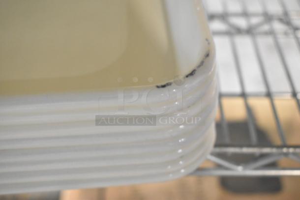 9 white poly pans, model BM407BUNIVFULL, stacked on a shelf. Features minor scratches on edges. New condition with defects.