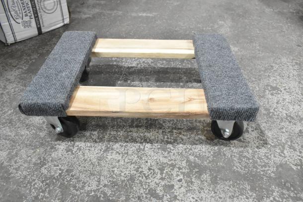Brand new Lavex 257WD1812 18"x12" wood dolly with carpeted ends, supports 800 lbs, 3" wheels, minor scratches.