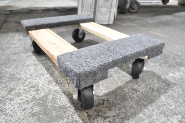 Brand new Lavex 18" x 12" wood dolly with carpeted ends, 800 lb capacity, and 3" wheels. Scratch and dent condition.