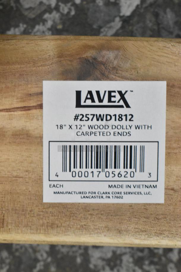 BRAND NEW Lavex 257WD1812 wood dolly, 18x12 inches, 800 lb capacity, carpeted ends, 3" wheels, minor scratches, label visible.