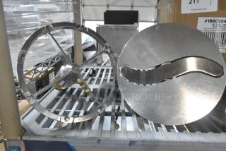 Brand new metal commercial pelican head items; S blade and blade frame, slightly scratched, tags visible on box.