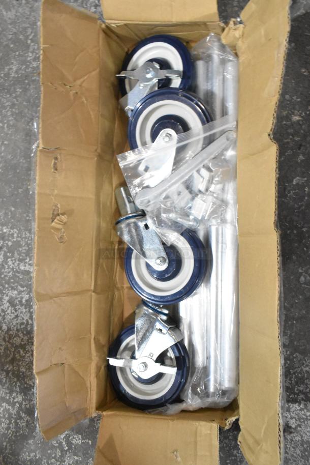 Lot of 4 commercial casters, brand new with minor scratches, blue and white wheels, metal brackets, in original open box.
