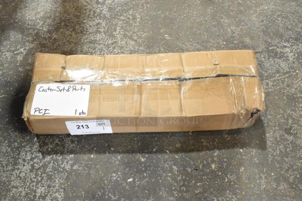 Box labeled "Caster Set & Parts" with clear tape, containing a lot of 4 new commercial casters, slight box damage visible.