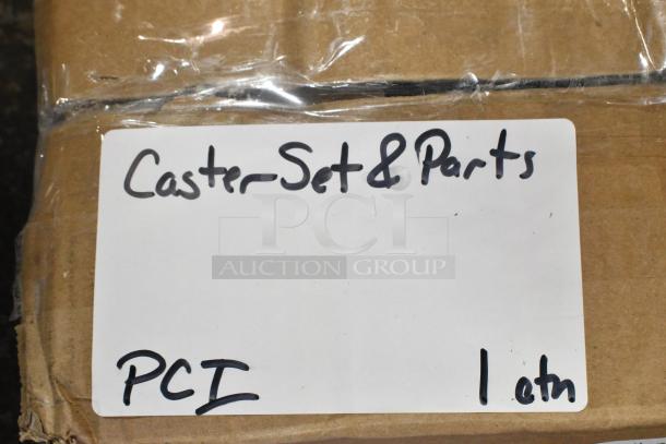 Box labeled "Caster Set & Parts, PCI, 1 Lot," containing a brand new lot of 4 commercial casters, scratch and dent condition.