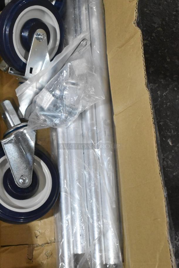 Lot of 4 brand new commercial casters, scratch and dent condition, includes metal frames and wheels in original packaging.