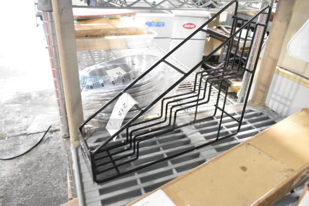 Black metal 4 tier stand, scratch and dent condition, new, label reads "215", sturdy design ideal for storage.